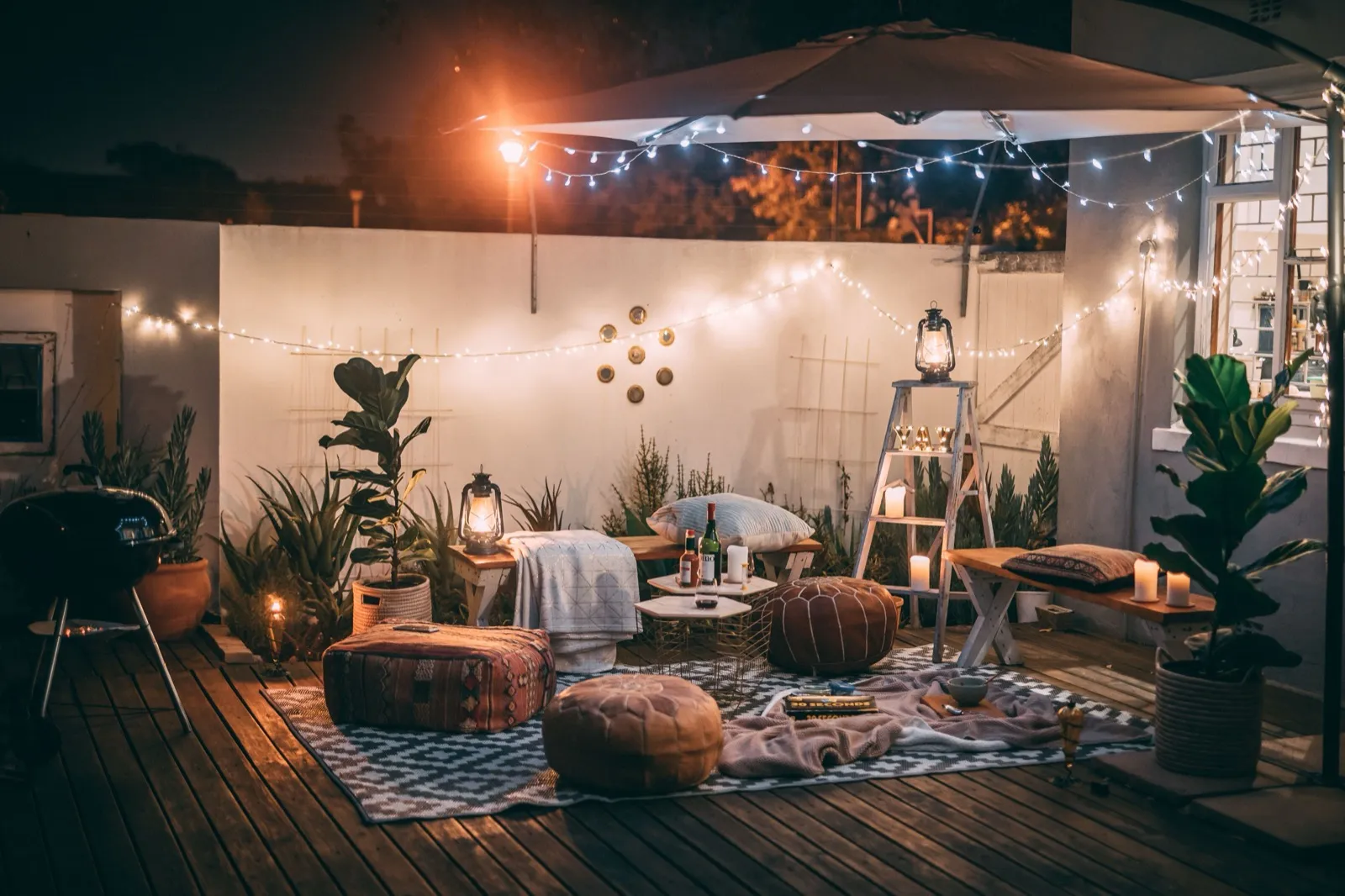 Landscape lighting illuminating a patio and garden path at dusk