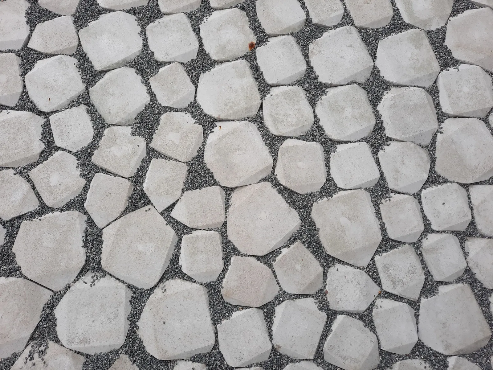 Stone pathway installation through a landscaped garden
